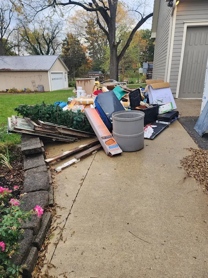 Dumpster being loaded with debris for 10 Yard Dumpster Rental in Bluffton